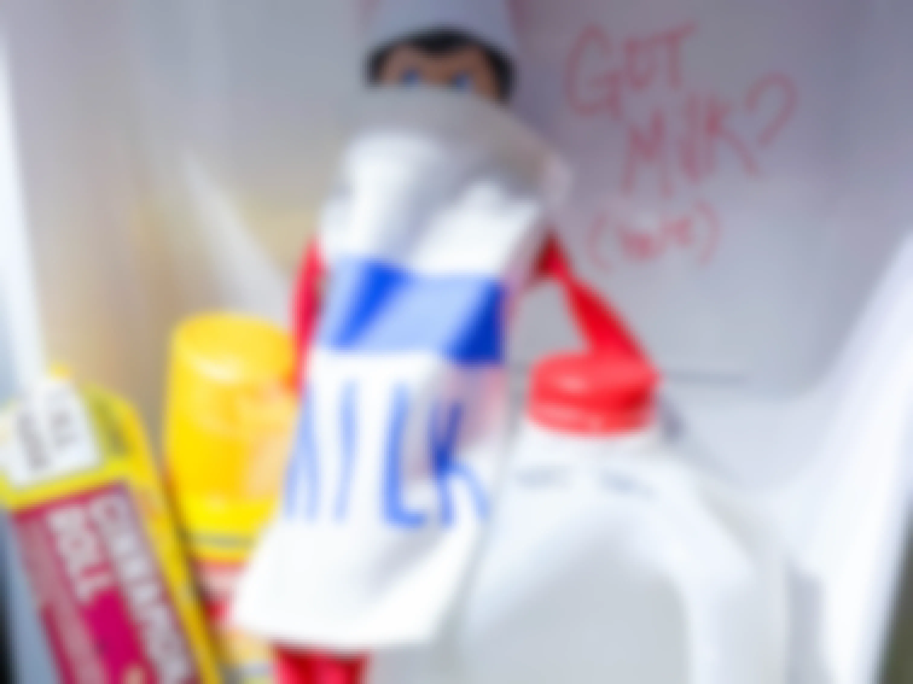 an elf on the shelf doll dressed like milk in a fridge drawer 