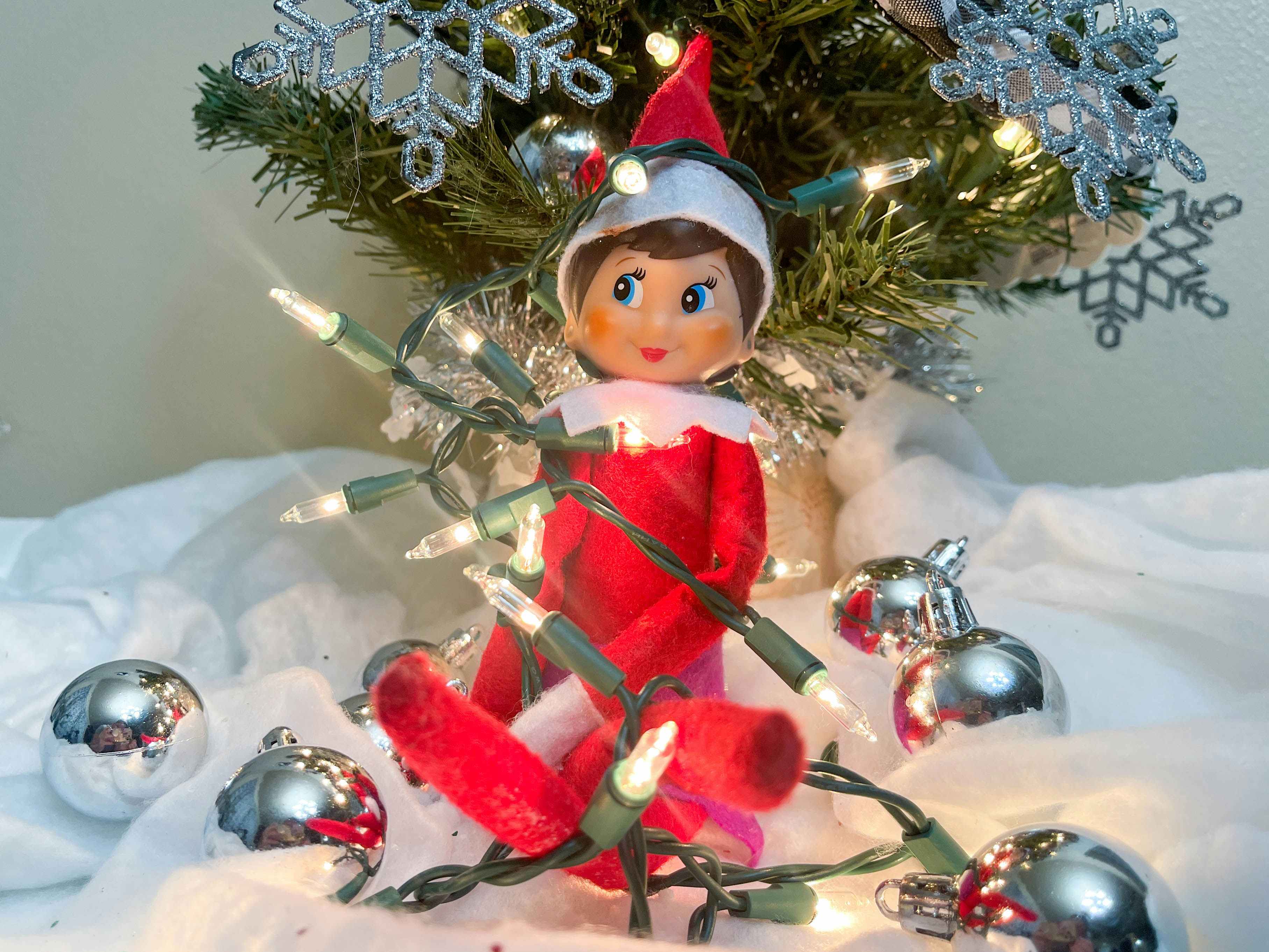 elf on the shelf doll tangled in a string lights 