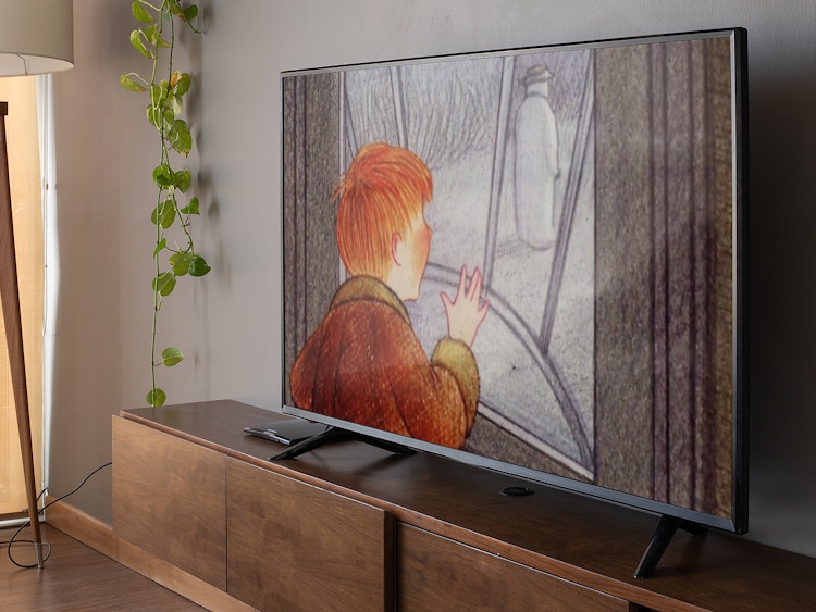 tv in living room showing The Snowman holiday movie
