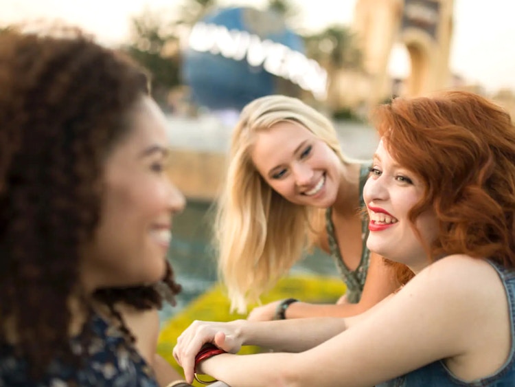 people laughing outside universal studios orlando entrance