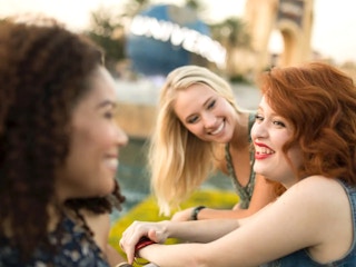people laughing outside universal studios orlando entrance