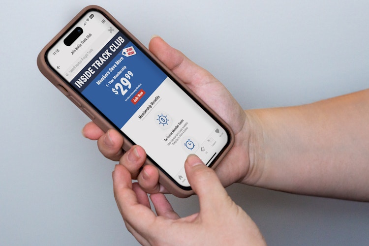 someone holding a phone displaying the Harbor Freight app Inside Track Club