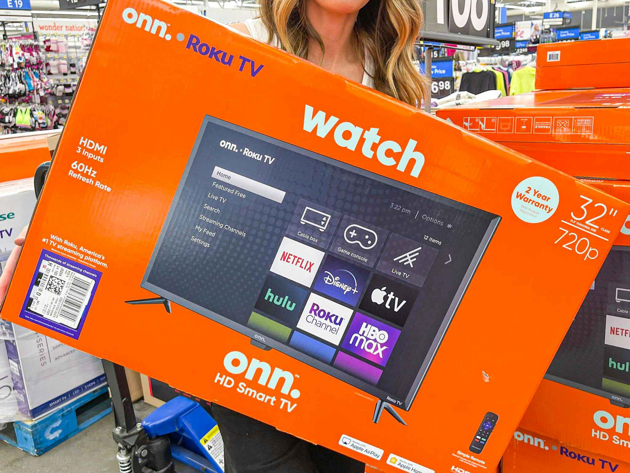 woman holding up tv box at Walmart