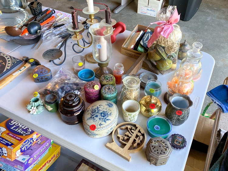 A table of knick-knacks in a garage sale