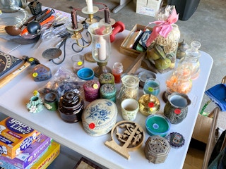 A table of knick-knacks in a garage sale