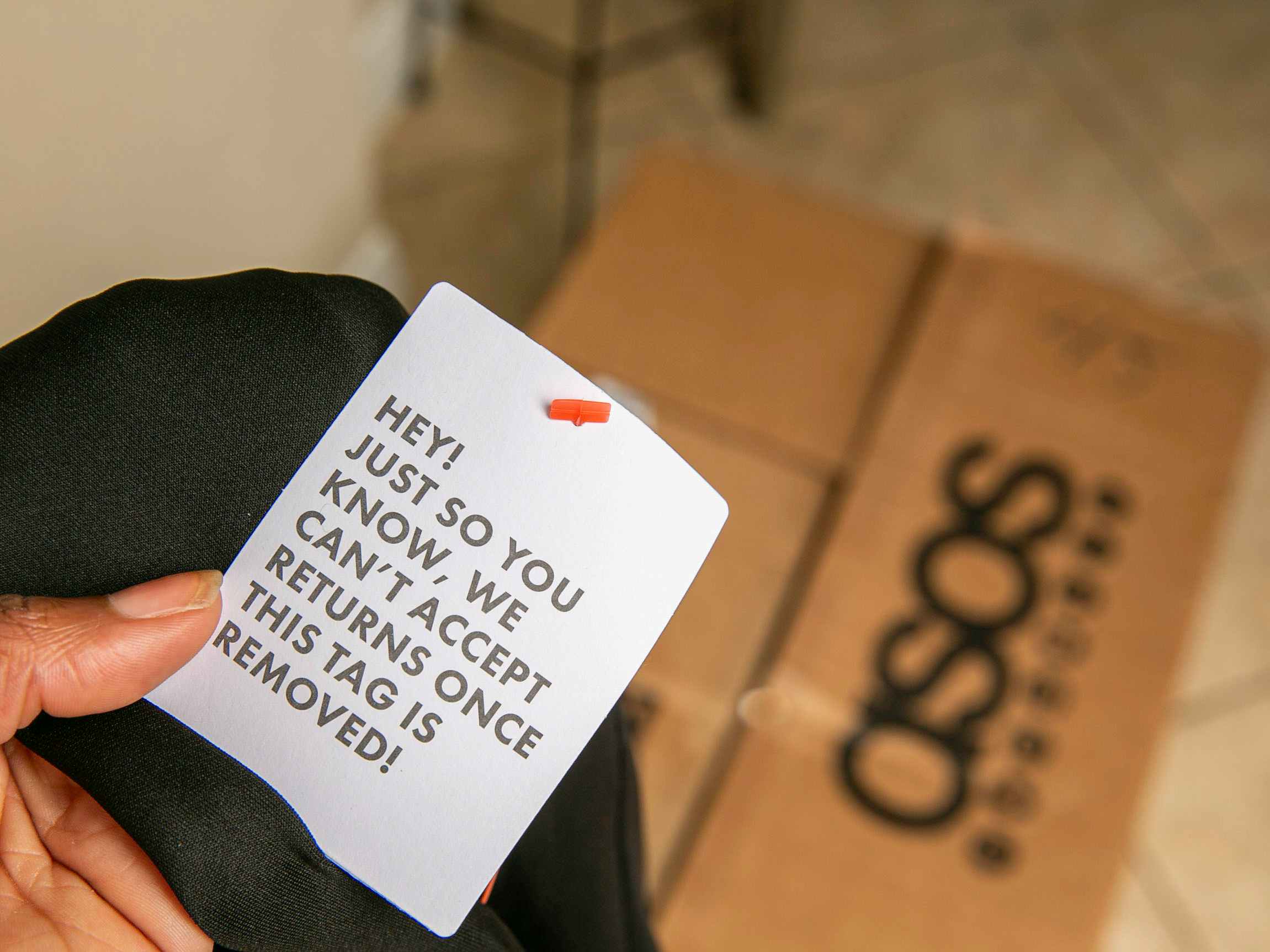 Asos clothing tag with a asos box in the background