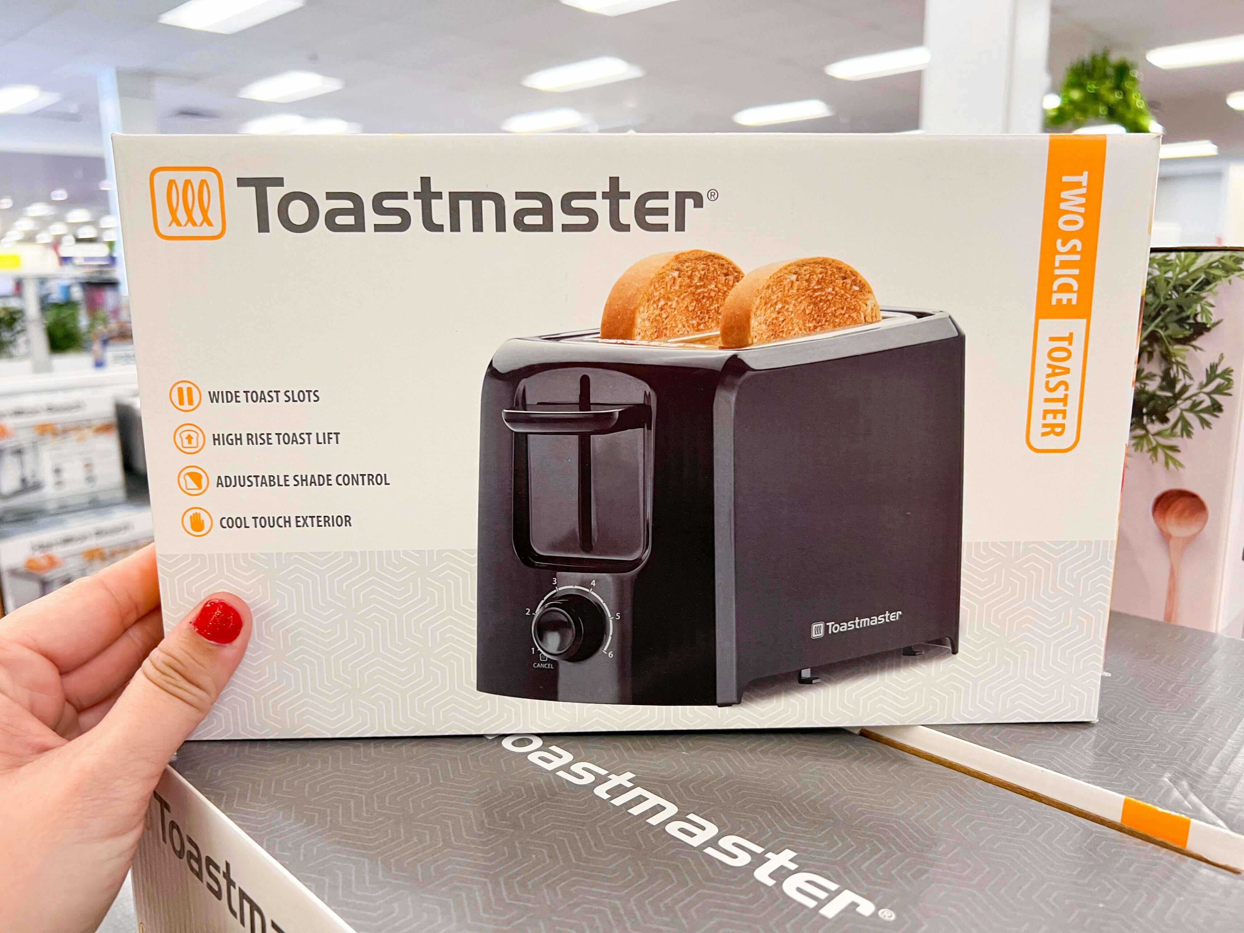 a person holding up a toastmaster toaster at kohls