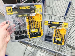 Hand holding up 14-Piece Dewalt Drill Bit Set in front of cart