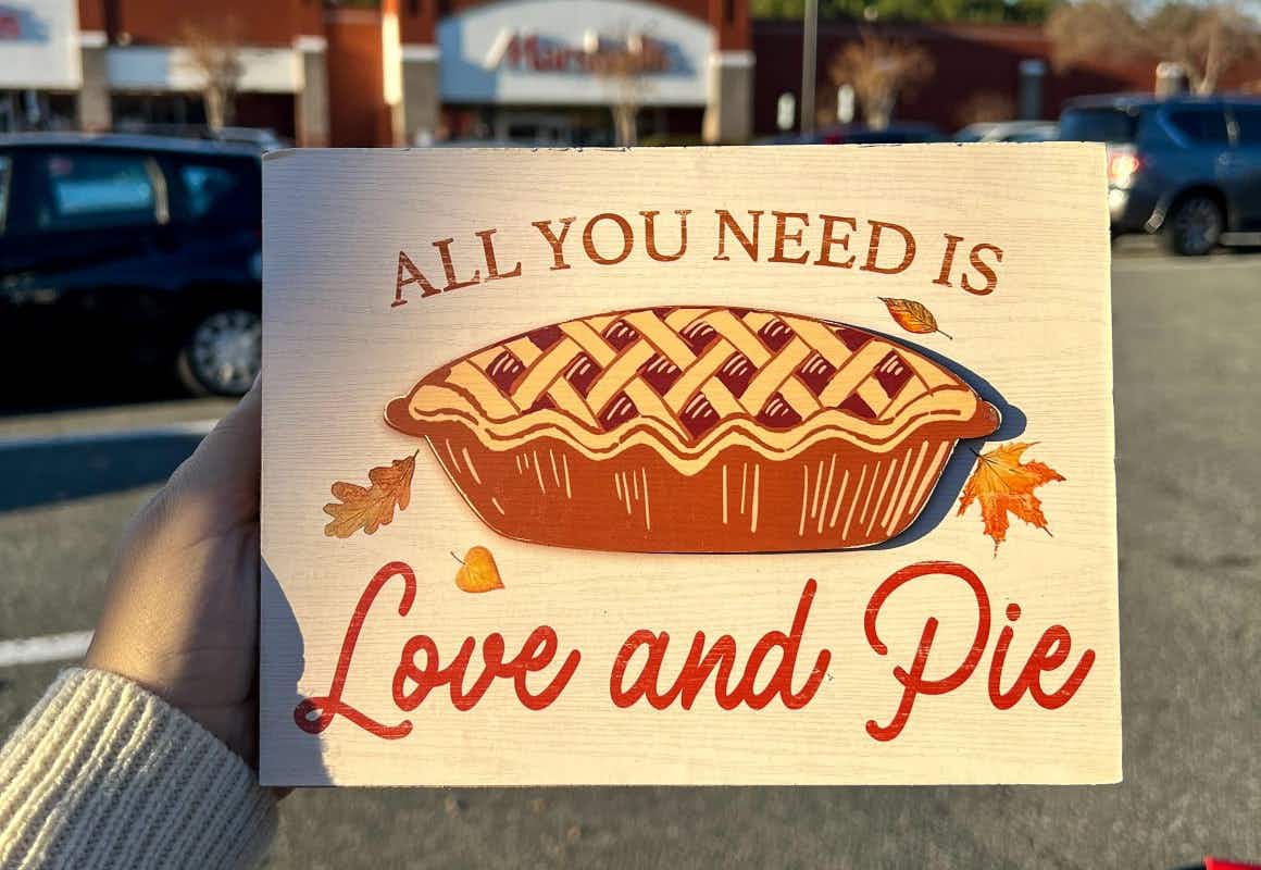 a sign that says all you need is love and pie with a pumkin pie on it