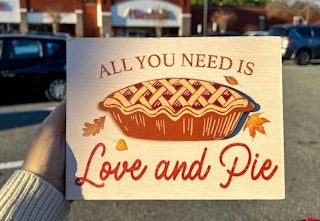 a sign that says all you need is love and pie with a pumkin pie on it
