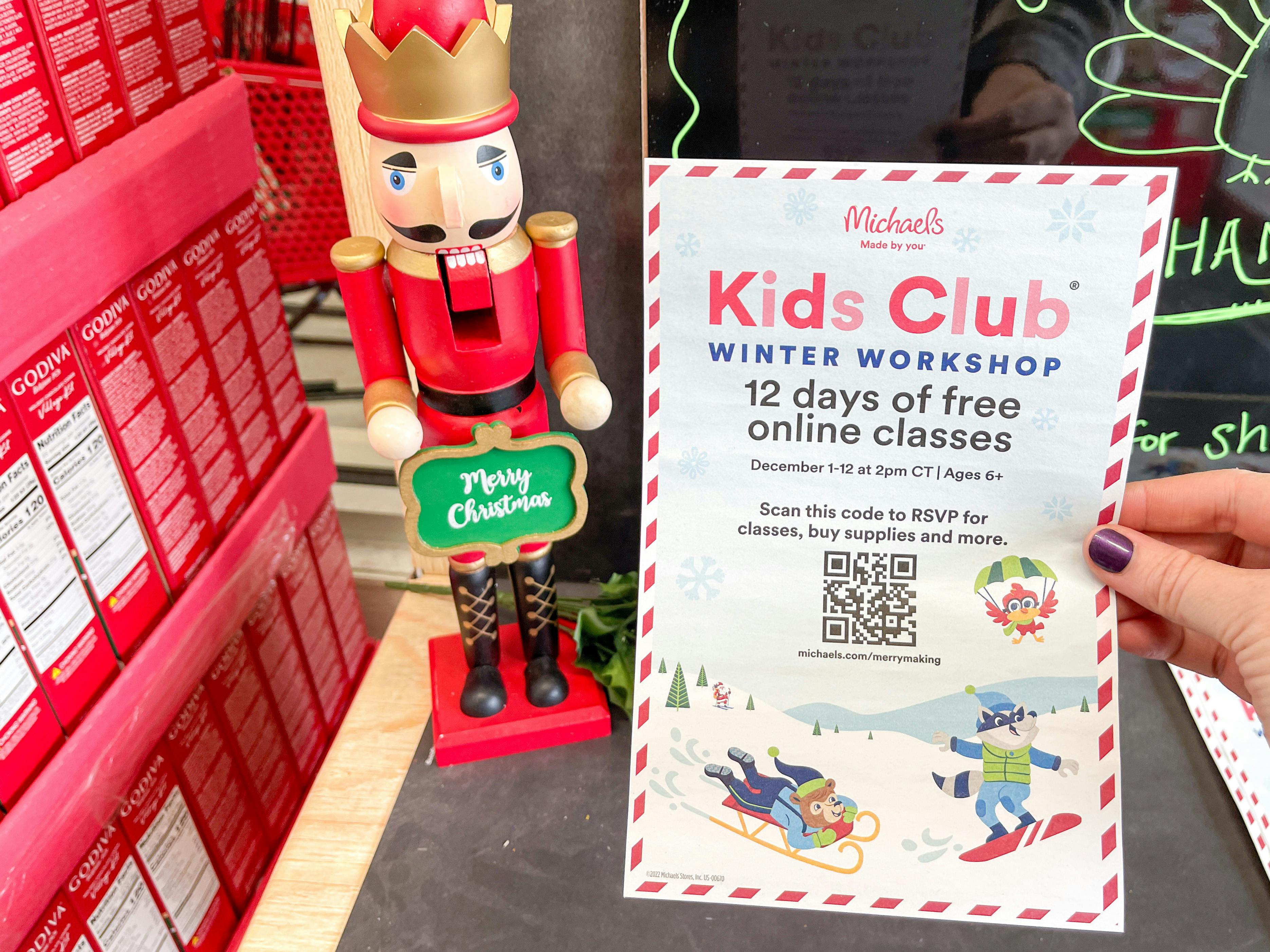 kids club flyer being held inside michaels store