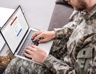 man in the military on laptop looking at id me website