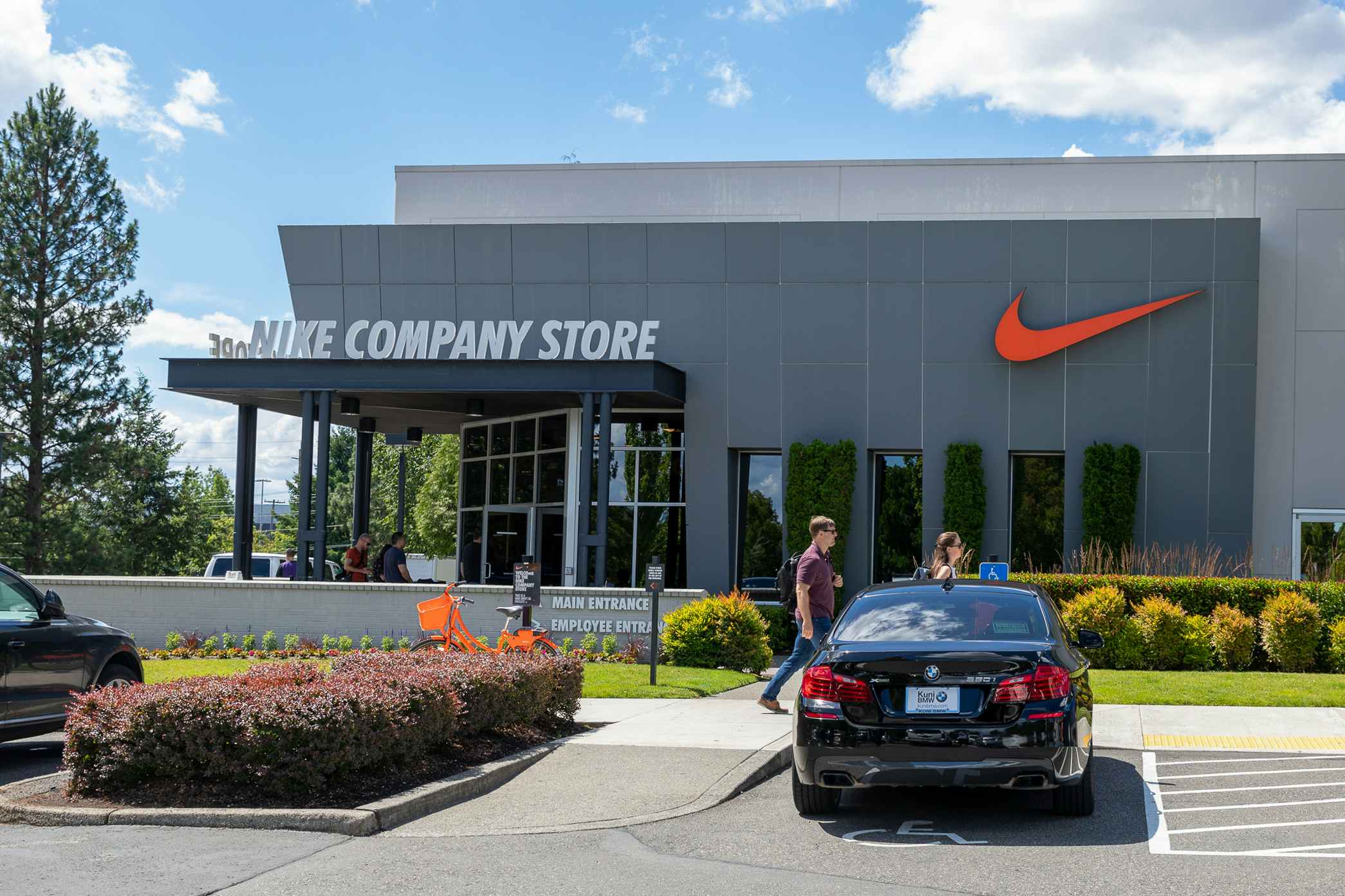The exterior of a Nike Company Store with people walking outside
