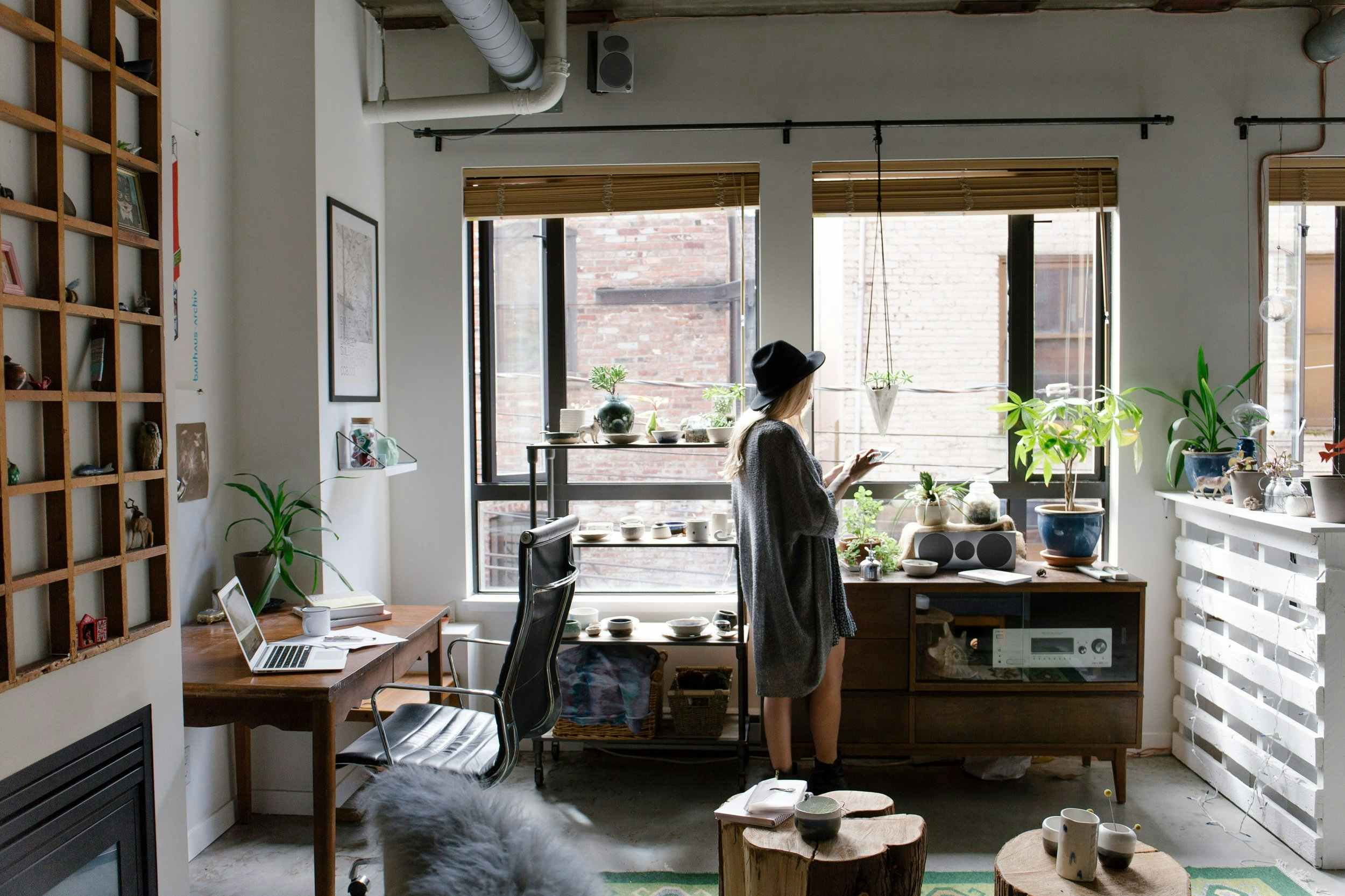 Woman standing in a well-lit living room.