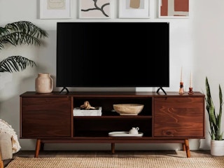Tv on a dark wood media console