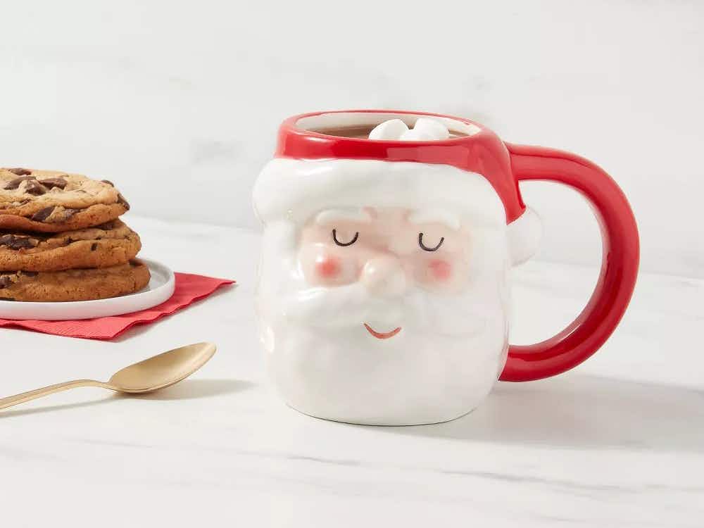 vintage santa mugs - A Stoneware Figural Santa Mug filled with hot chocolate, sitting on a counter next to some cookies