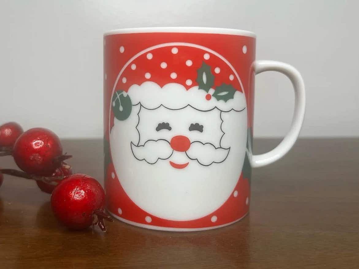 vintage santa mugs - A Vintage Christmas Mug on a table