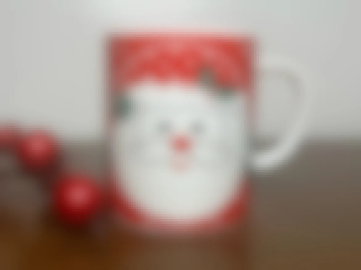 vintage santa mugs - A Vintage Christmas Mug on a table