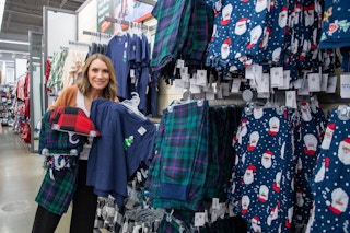A woman holding some comfy clothes inside an Old Navy