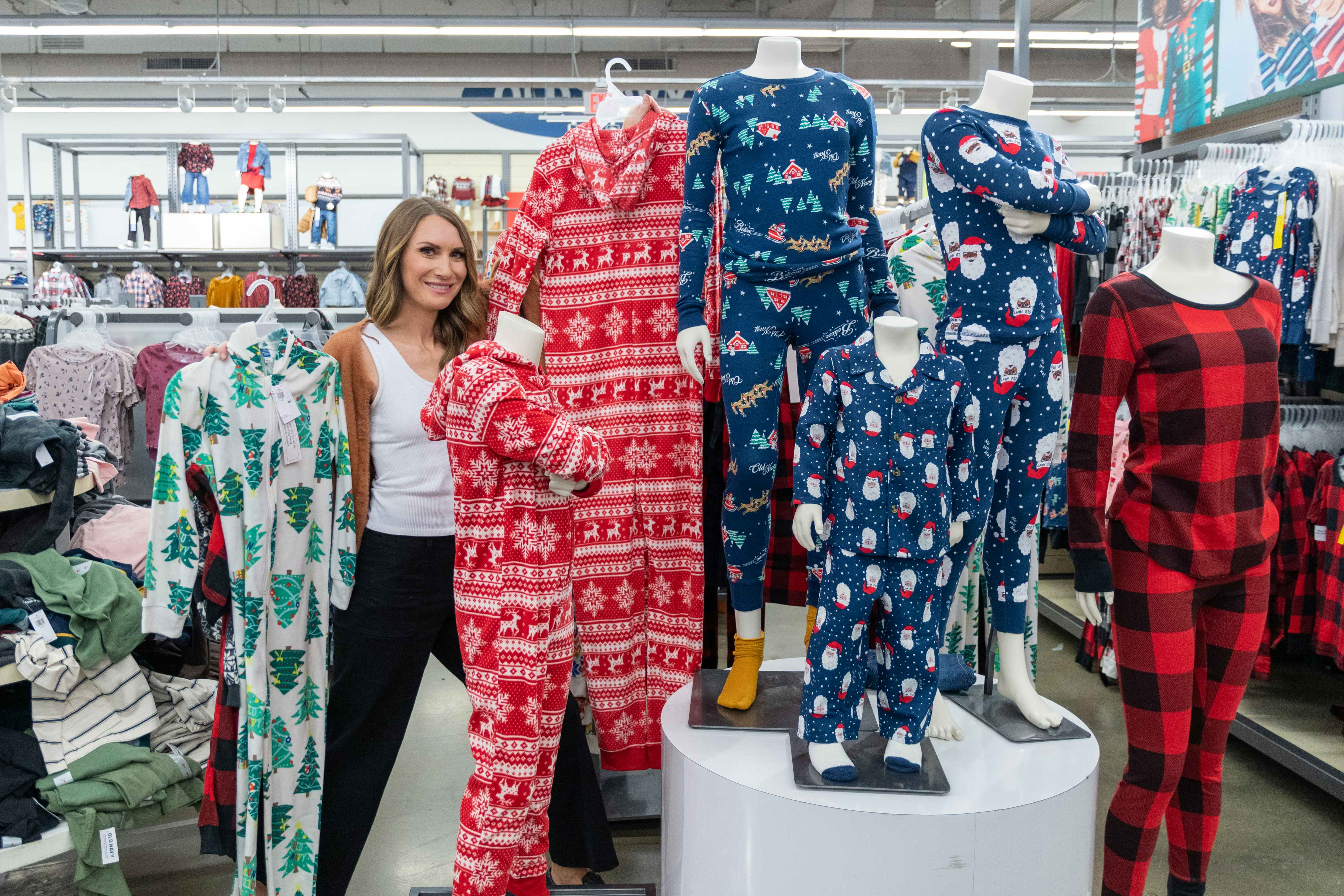 A woman posing with some onesie family pajamas in Old Navy