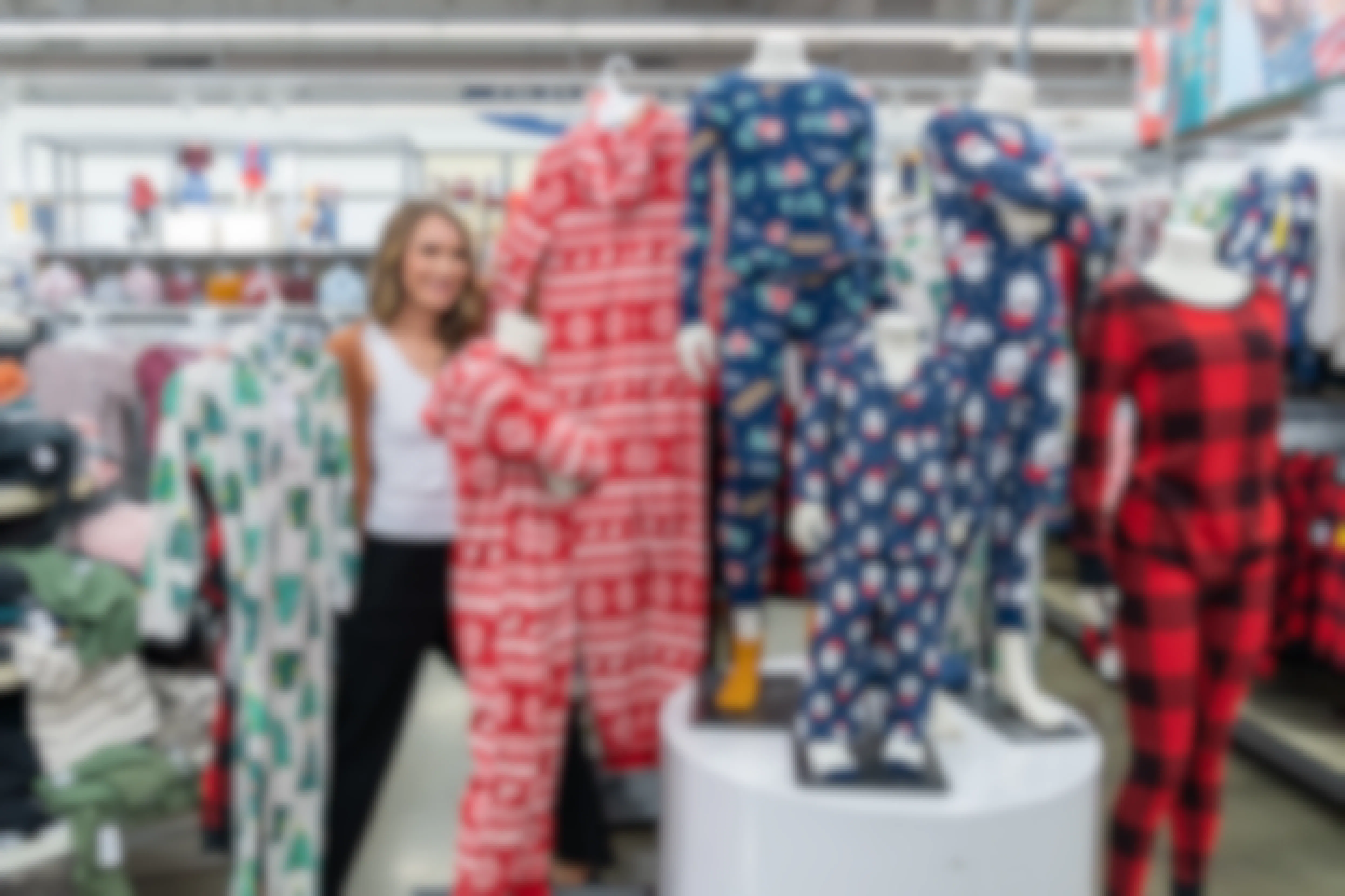 A woman posing with some onesie family pajamas in Old Navy