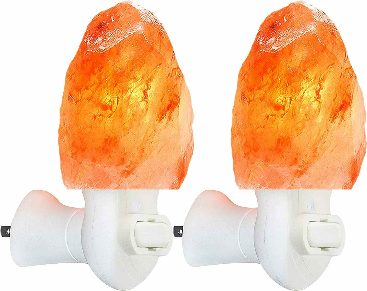 Two Himalayan salt lamp night lights on a white background