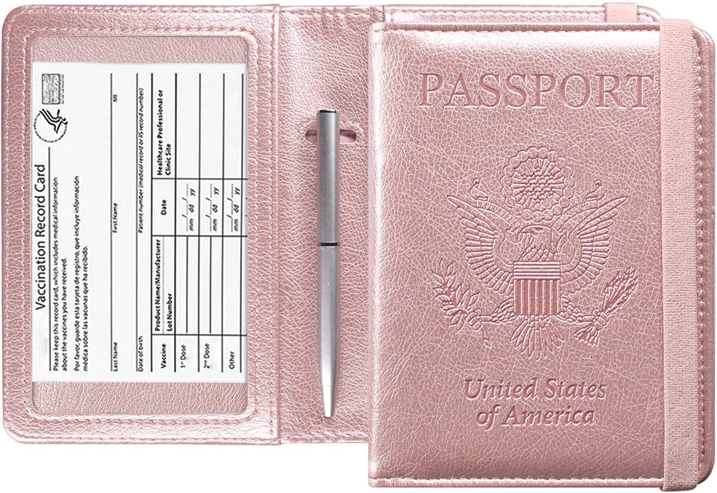 A pink passport cover with a vaccine card shown in the window pocket