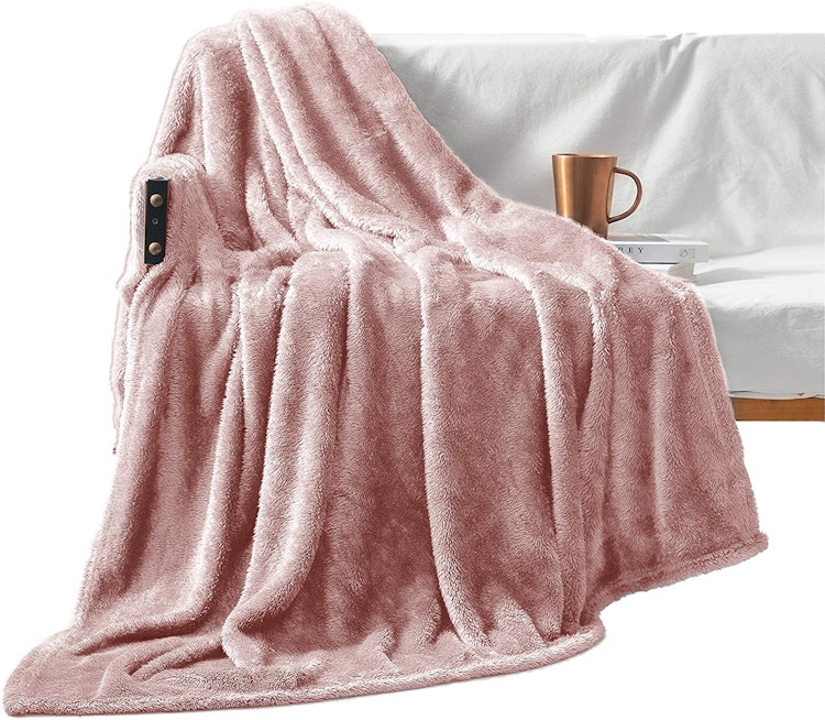 A Mezcla Plush Extra Large Fleece Throw on a the side of a couch