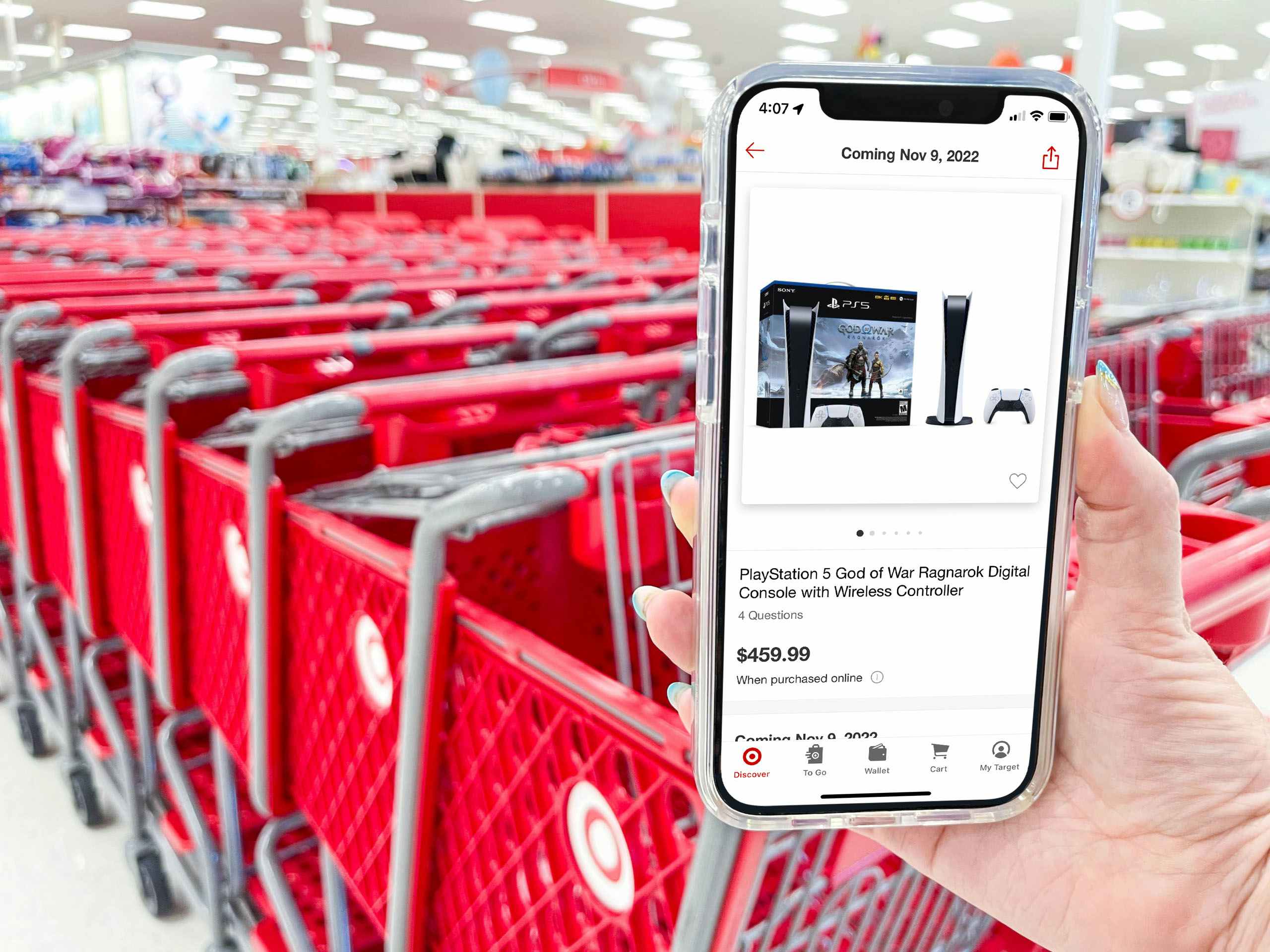A person holding up their phone displaying the PS5 product page on the Target app at the entrance of Target