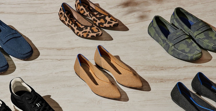 Pairs of Rothy's shoes lined up on a wooden floor