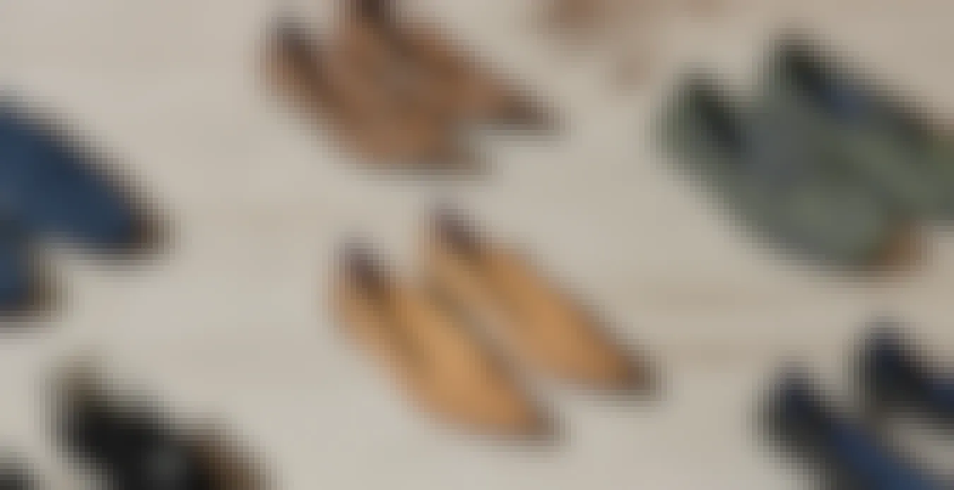 Pairs of Rothy's shoes lined up on a wooden floor
