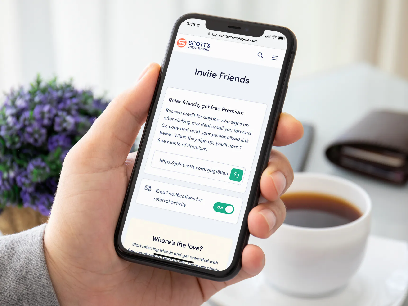 A person holding a cell phone displaying the Invite page on the Scott's Cheap Flights website
