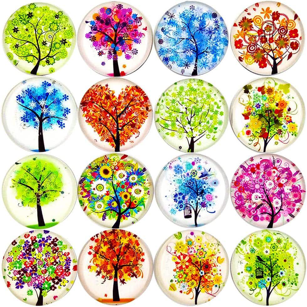 Some colorful floral magnets on a white background