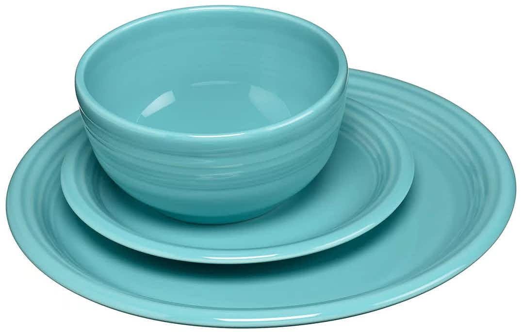 a set of colorful plates and bowls on a white background