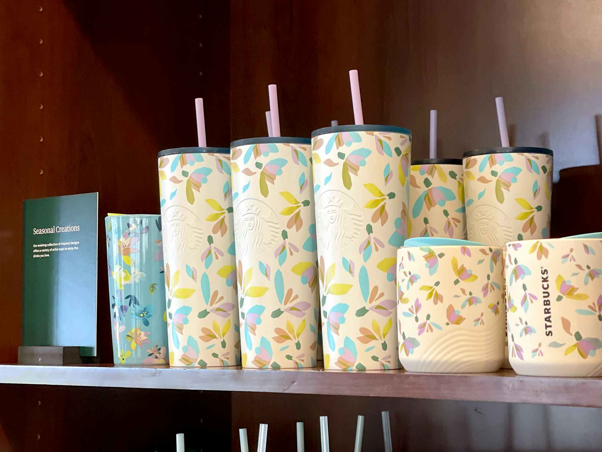 Starbucks pastel flower tumblers on shelves in store 