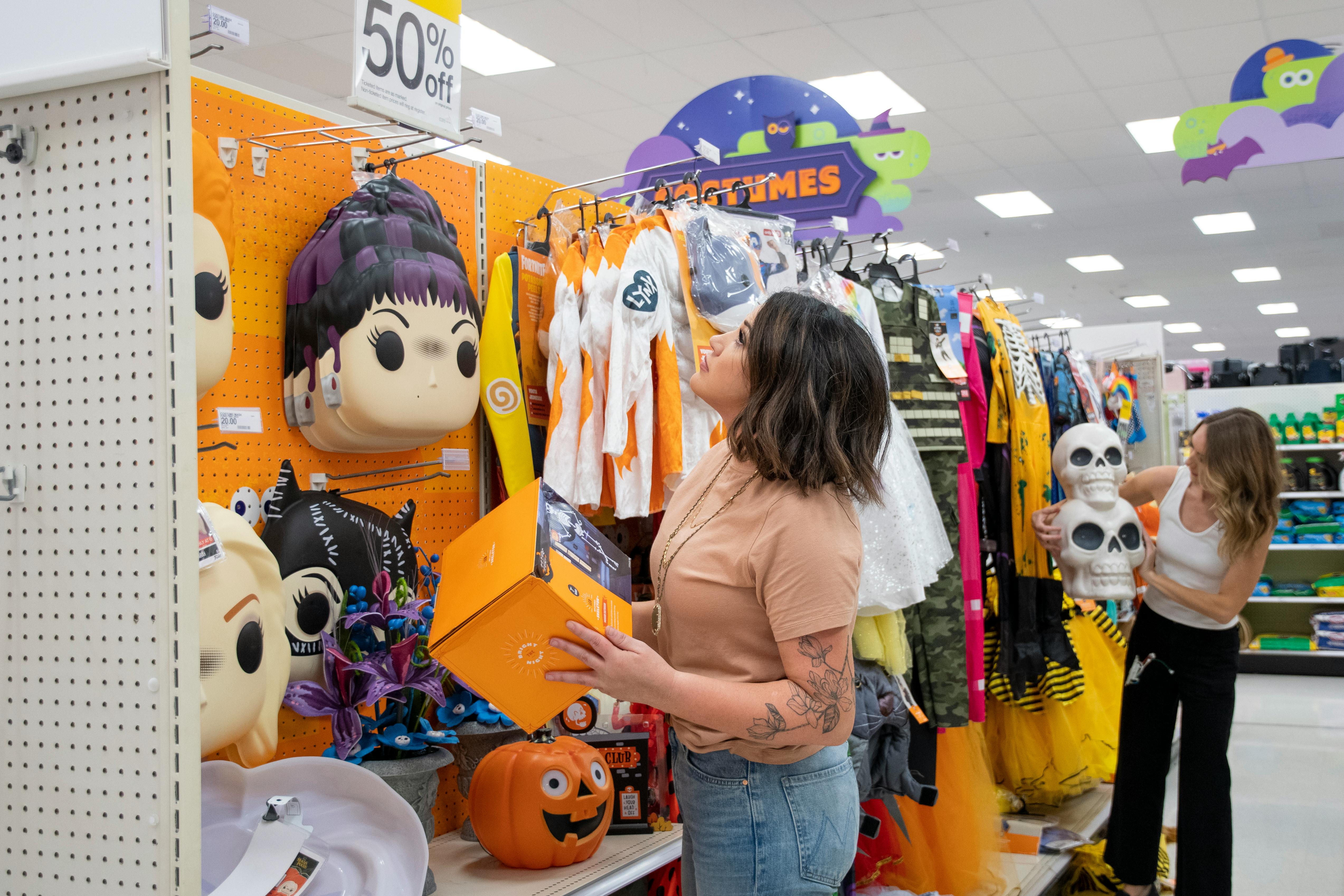 two people shopping for Halloween items at Target