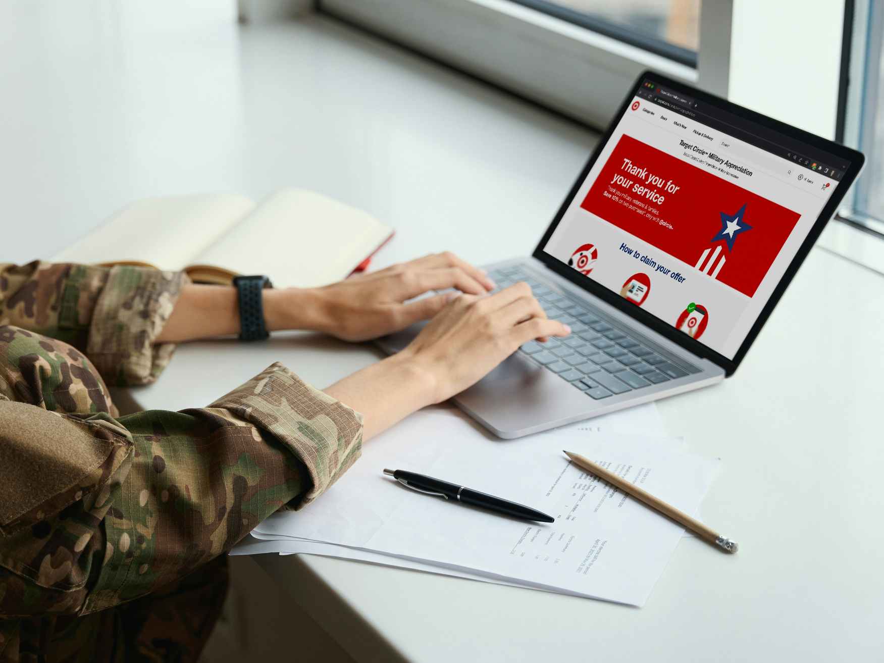 A person in military dress looking at the Target webpage about their military discount