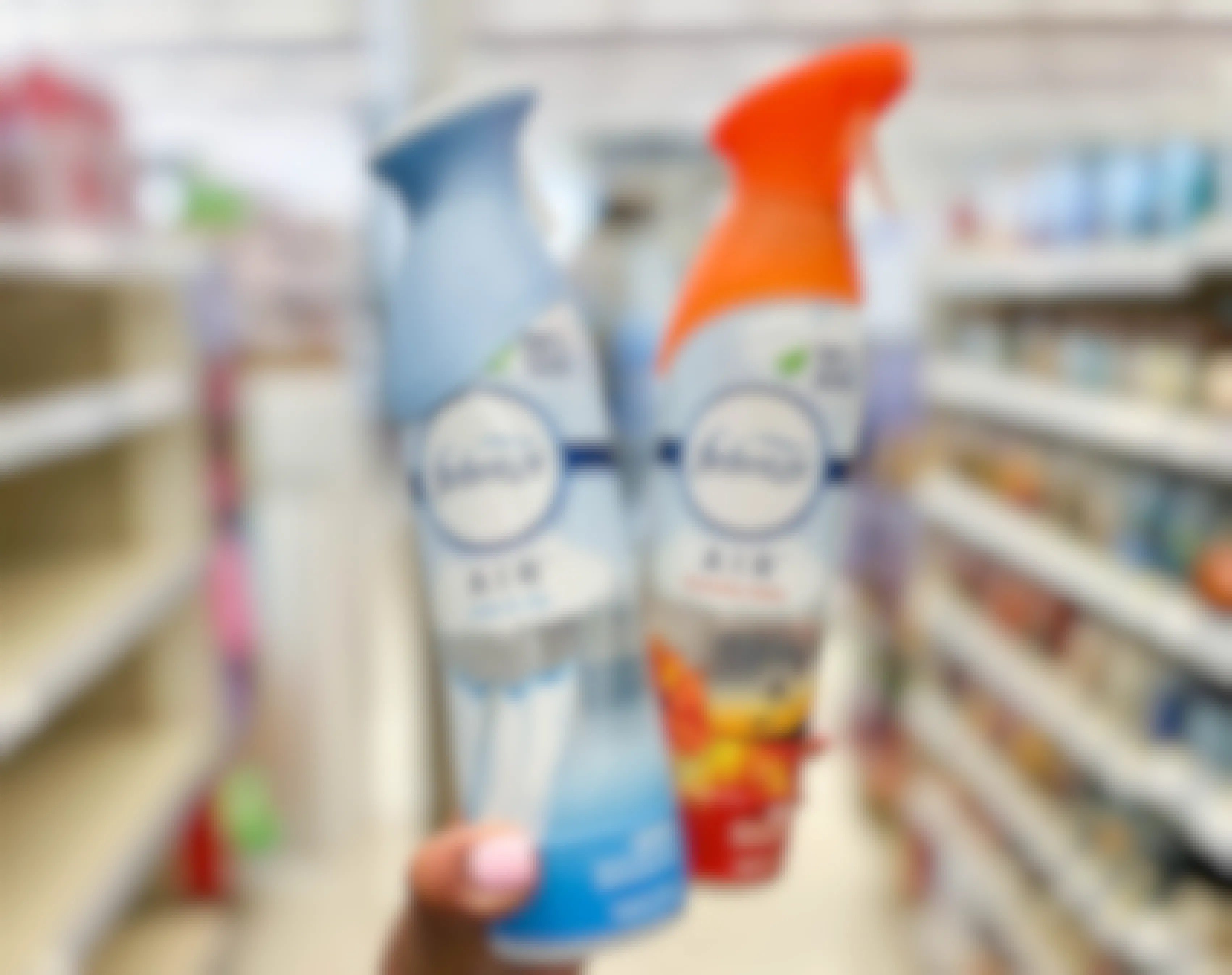 two cans of Febreze air freshener in aisle