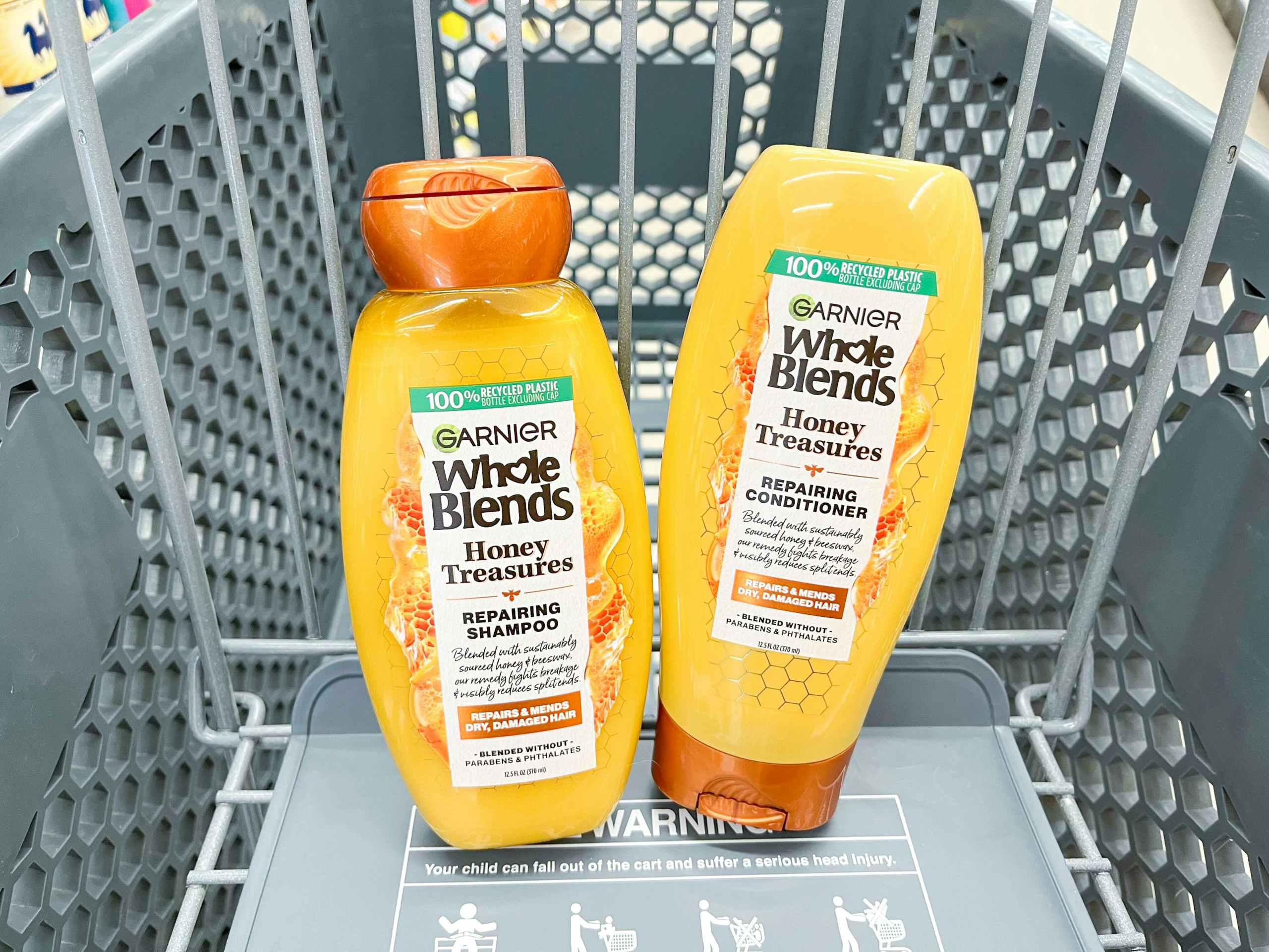 one bottle of Garnier Whole Blends shampoo and conditioner inside cart