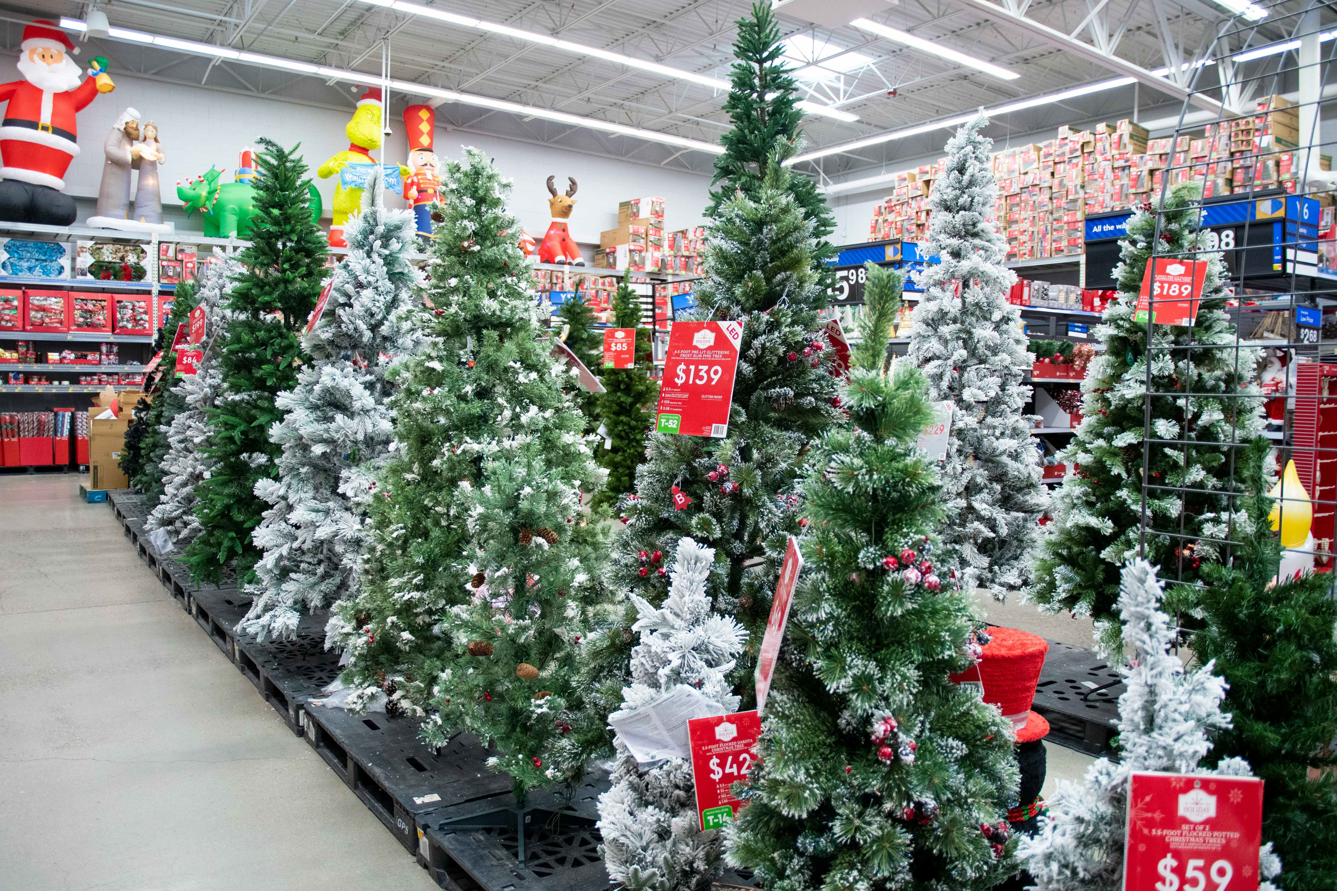 a display of artificial Christmas trees at Walmart