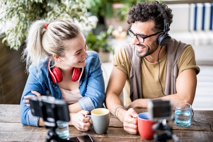 Two content creators speaking to each other while recording a video