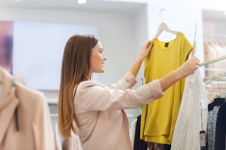 Woman Shopping in store, looking at a yellow