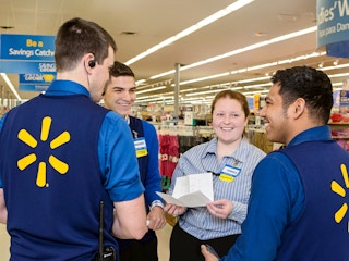 Some Walmart employees talking to each other before a shift