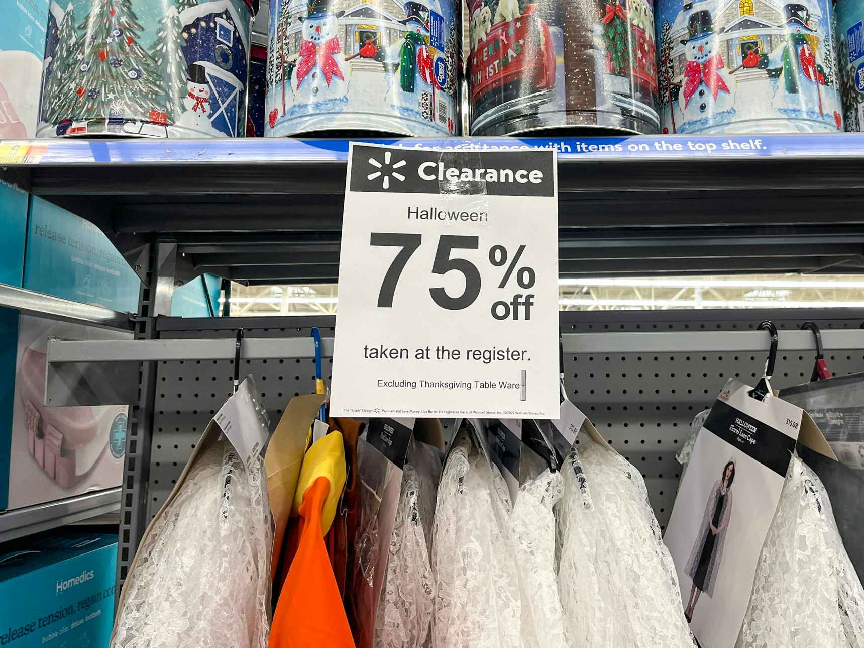 A 75% off clearance sign in the Halloween costume section in Walmart