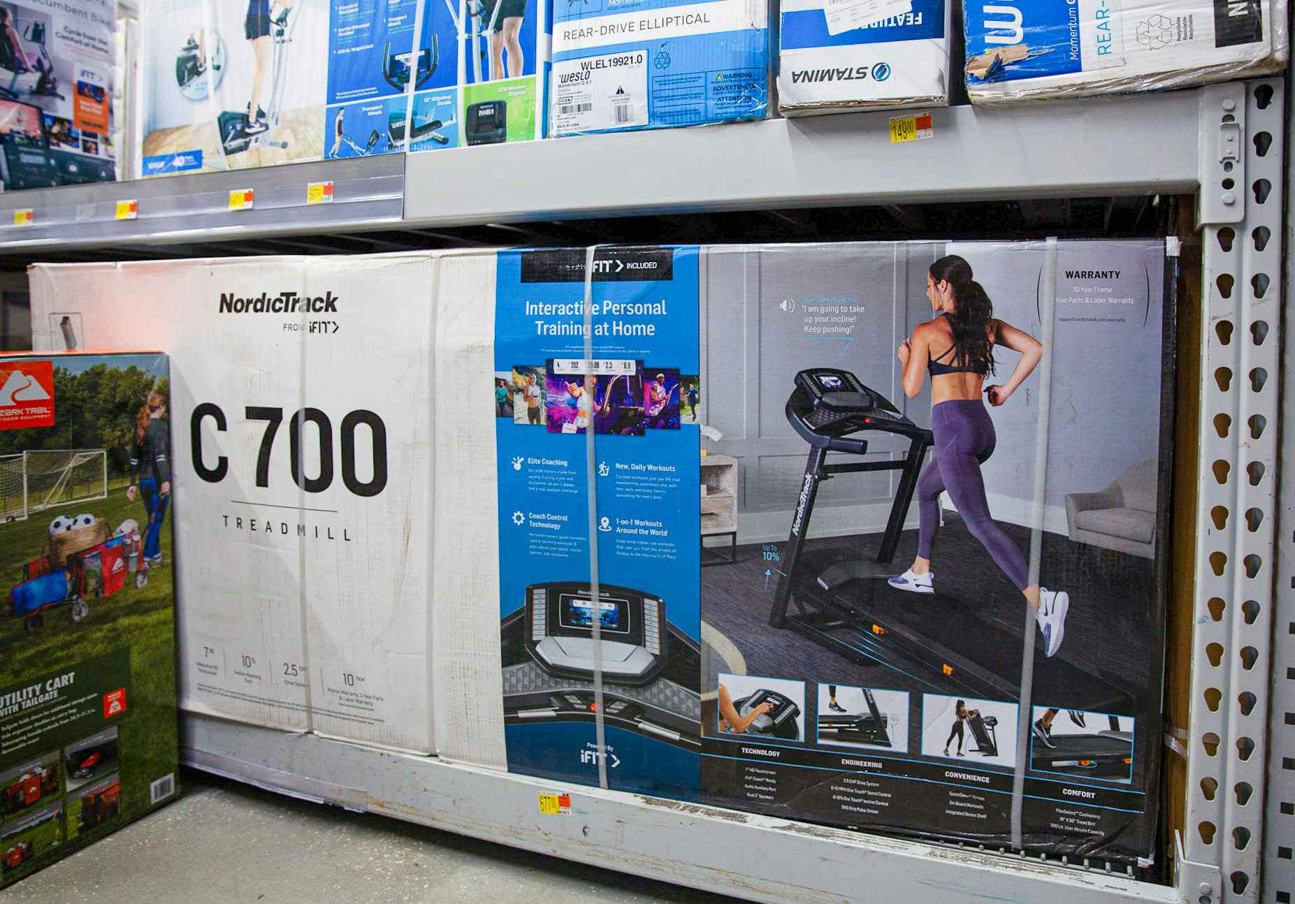 A NordicTrack c700 treadmill in its box on a Walmart shelf