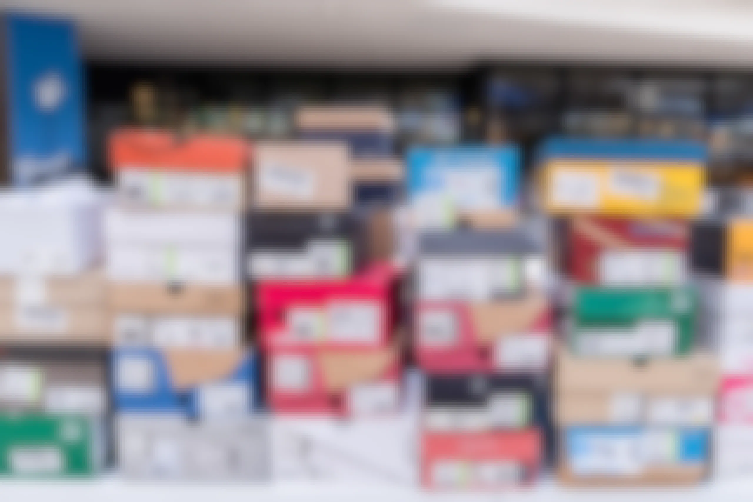 Different brands of shoes in their boxes in a stack
