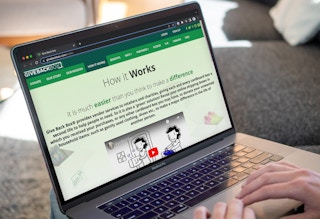 Someone looking at the Give Back Box website for amazon shipping box donations