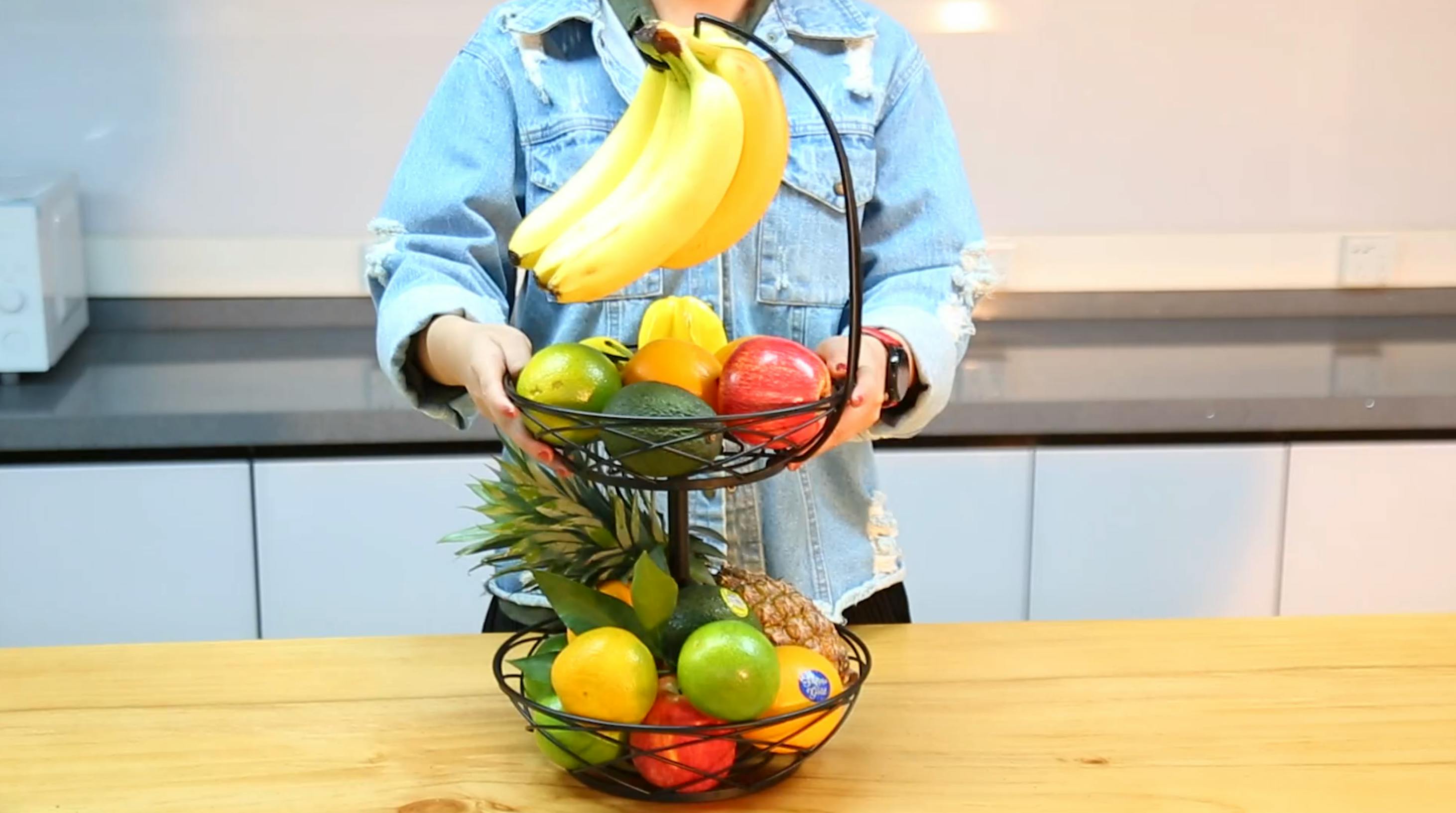 person setting up a fruit basket
