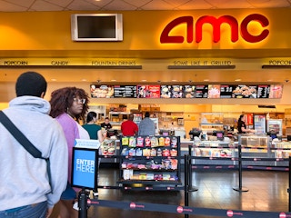 two people entering the concessions line at AMC