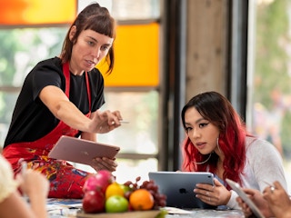 college art professor and students with ipads